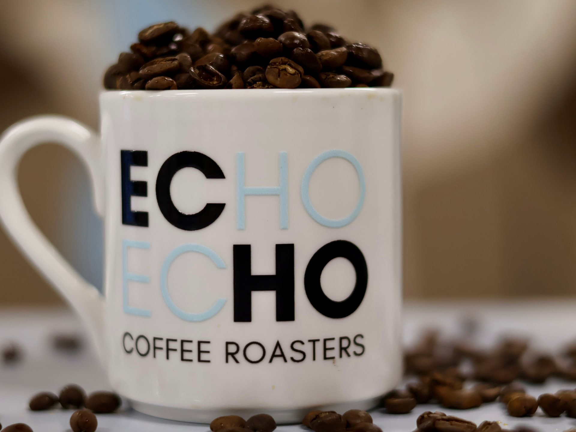 Freshly roasted ECHO Coffee Roasters beans in a mug